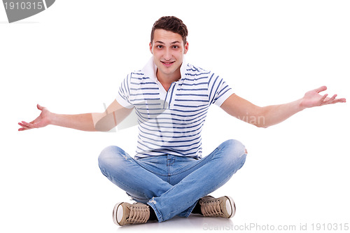 Image of man seated on studio, welcoming