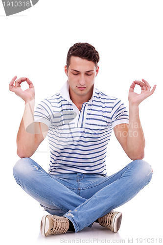 Image of young handsome man meditating