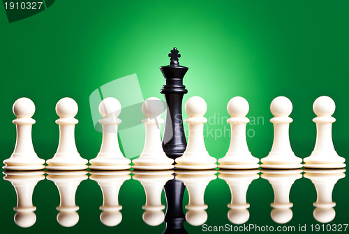 Image of white pawns in front of a black king 