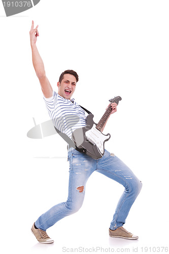 Image of young casual man playing an electric guitar 