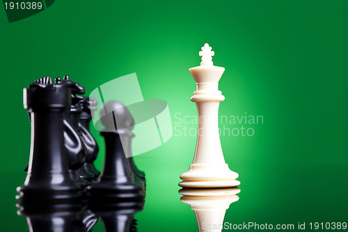 Image of white king in front of the black chess pieces