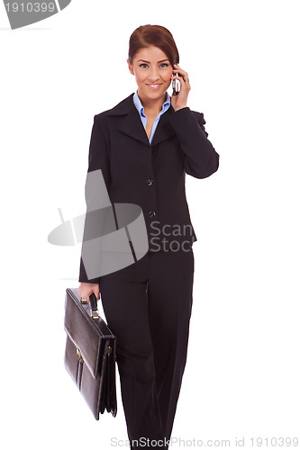 Image of walking business woman on the phone