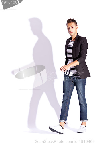 Image of side view of a young casual fashion man  walking