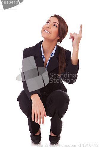 Image of  business woman standing down and pointing up