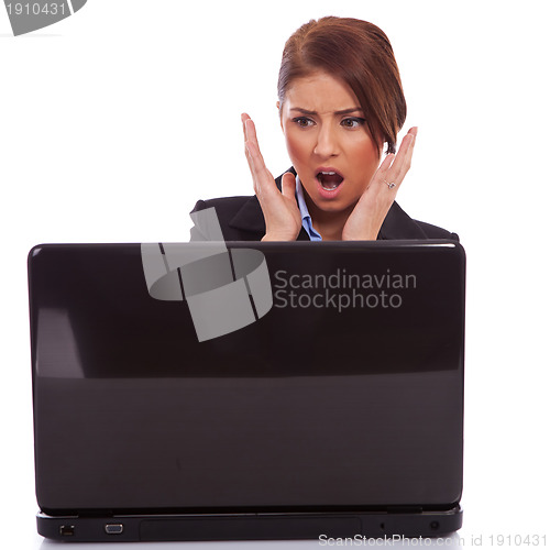 Image of business woman reading bad news at laptop