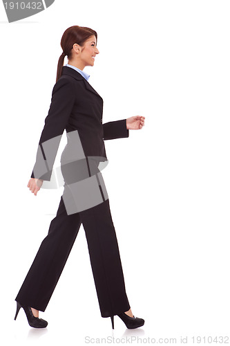 Image of side view of a young business woman walking