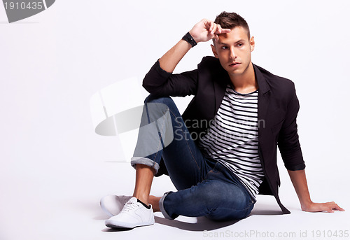 Image of fashionable young casual man sitting
