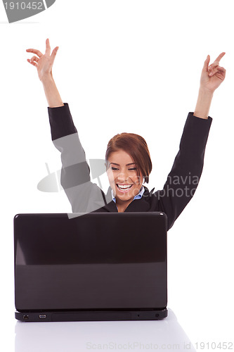 Image of  business woman in office jubilates at desk