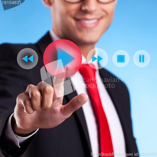 Image of business man pushing a play button