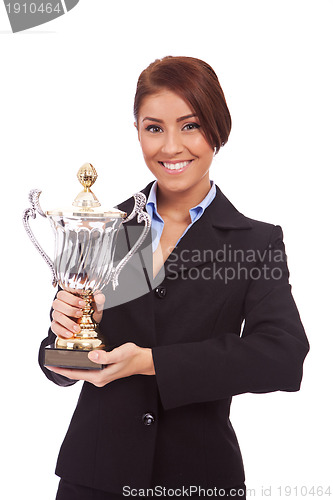 Image of young business woman holding her big trophy 