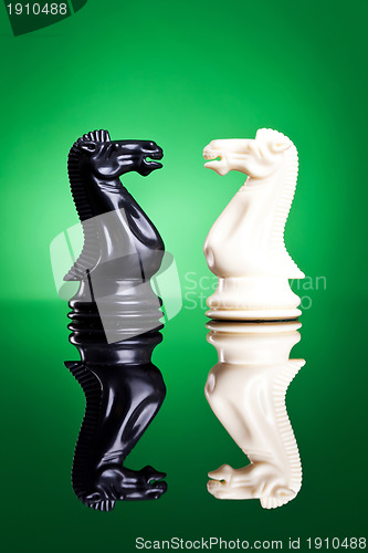 Image of white and black knights facing aeach other