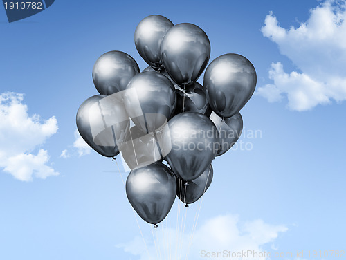 Image of silver balloons on a blue sky