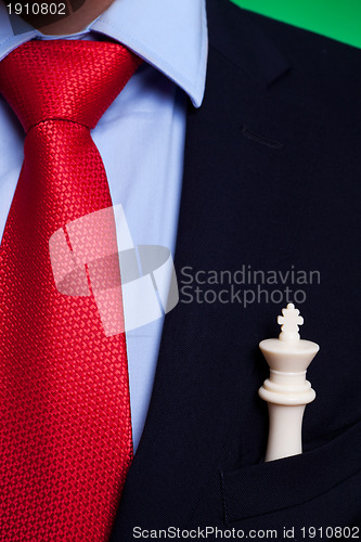 Image of  chess king in the pocket of a business man
