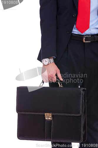 Image of Business man in black suit hand holding briefcase