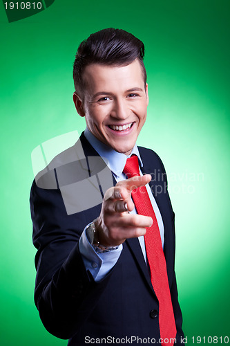 Image of young business man points finger 