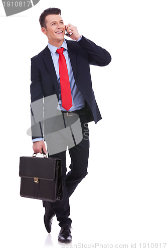 Image of  business man with briefcase talking on the phone