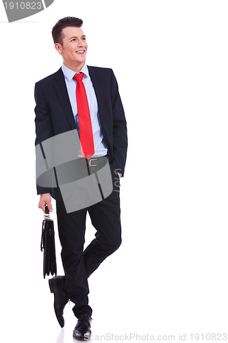 Image of young business man with suitcase looking to side