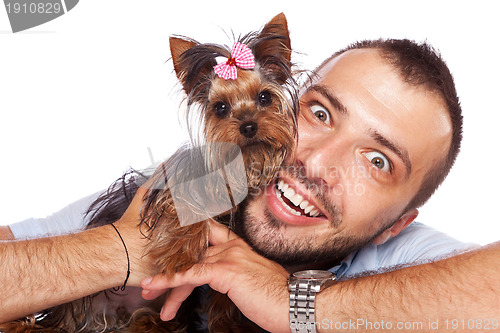 Image of young man holding a cute yorkie puppy dog