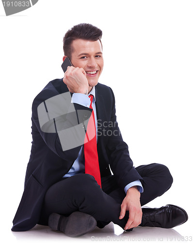 Image of seated businessman talking on the phone