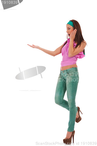 Image of young woman in jeans and high heels shoes presenting