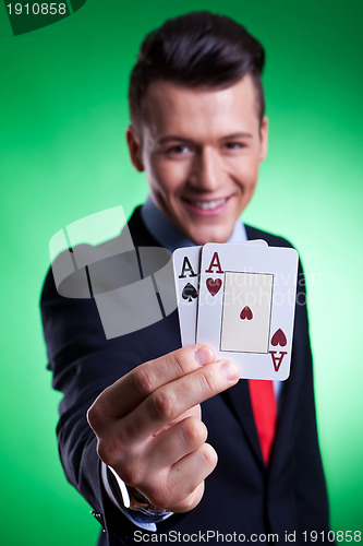 Image of business man holding a pair of  aces 