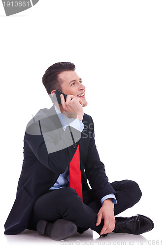 Image of seated young business man talking on the phone