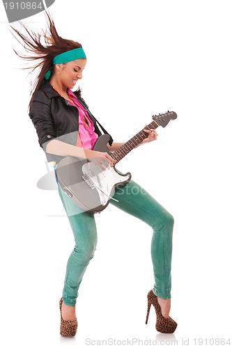 Image of  woman guitarist playing rock and roll 