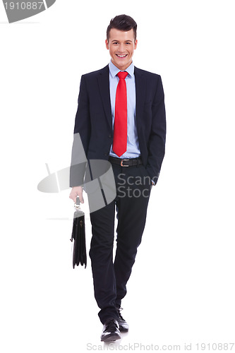 Image of young business man carrying a suitcase