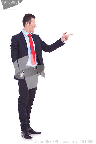 Image of  handsome young business man pointing to his side
