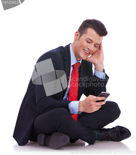 Image of business man sending or reading a text message