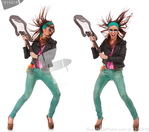 Image of hot excited rock and roll woman breaking guitar