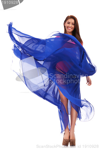 Image of happy young woman in blue long wavy dress 