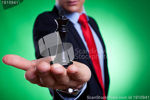 Image of king of chess in the palm of a young business man