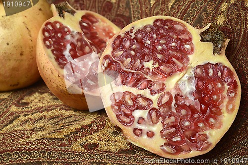Image of two pomegranates, one open in the foreground