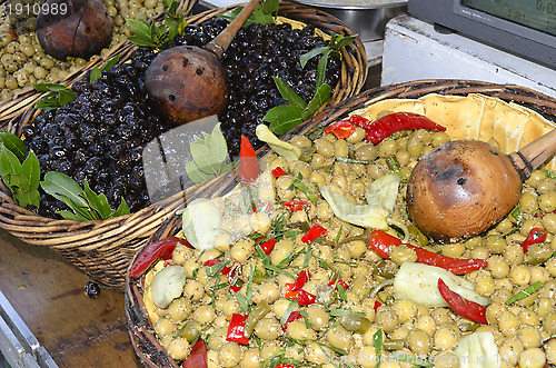 Image of baskets of olives on the market