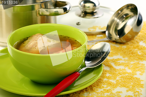 Image of Soup in bowl and stainless steel pan.