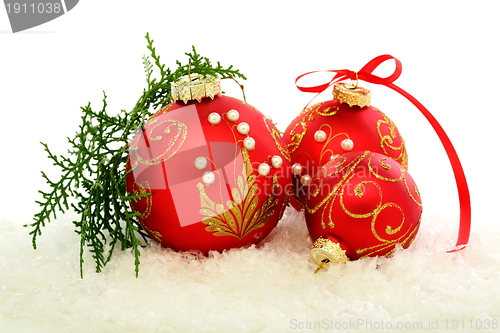 Image of Christmas red balls on the snow.