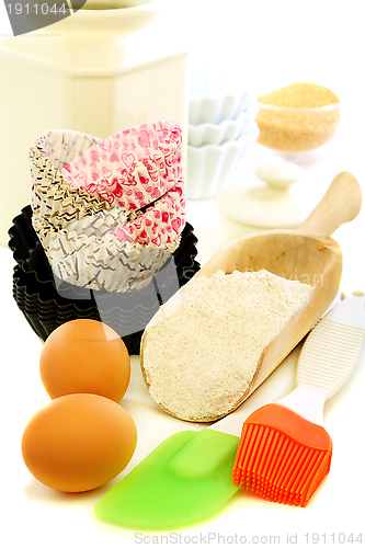 Image of Forms for baking cakes and scoop of flour.