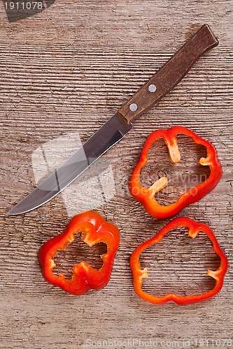 Image of sliced red bell peppers and old knife