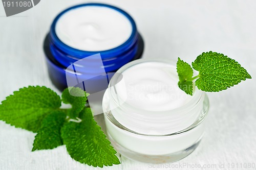 Image of face cream in jars with urtica 