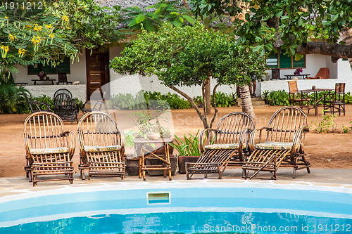 Image of Chairs on swimming pool border