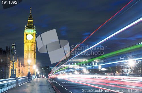 Image of Tower Bridge in London, UK at night with traffic and moving red 