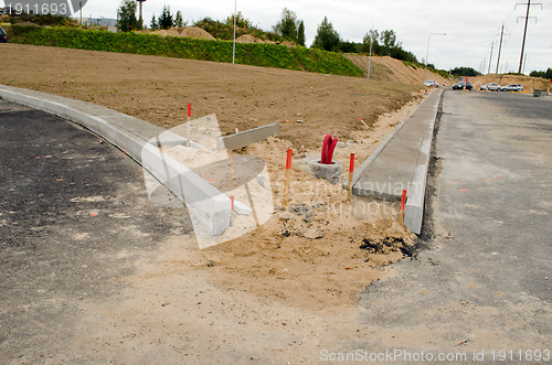 Image of road construction site car go light pole wires 