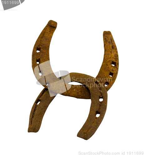 Image of Crossed retro rusty two horseshoes on white 