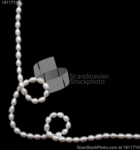 Image of White pearls on the black silk 