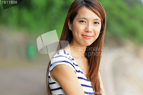 Image of young woman smiling friendly outdoor