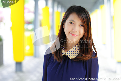 Image of young woman smiling friendly on street