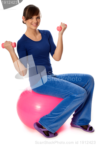 Image of Exercises with dumbbells on a gymnastic ball