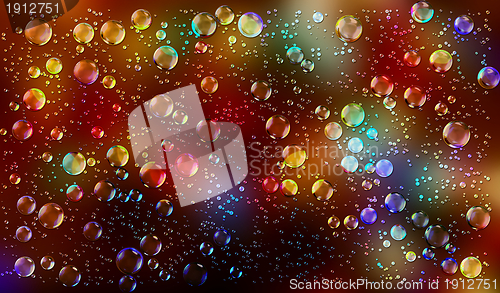 Image of Cheerful colors of raindrops on the window