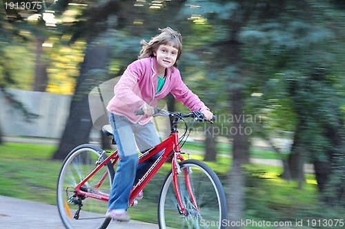 Image of Cute Happy girl riding bike